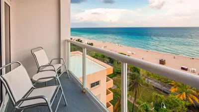 a balcony with chairs and a view of the beach at Best Western Plus Atlantic Beach Resort in Miami Beach