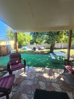 a patio with two chairs and a swing at The Jazzy Escape in Miami
