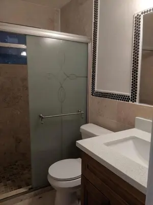 a bathroom with a shower with a toilet and a sink at The Jazzy Escape in Miami