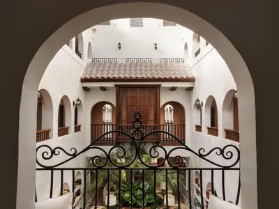 an arched entryway to a building with a balcony at Casa Faena Miami Beach in Miami Beach