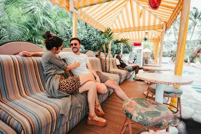 a man and a woman sitting on couches at Viajero Miami in Miami Beach
