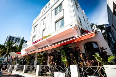 a white building with a sign on it at Viajero Miami in Miami Beach
