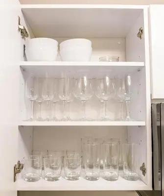 a cupboard filled with lots of empty glasses at Top Stay Miami Blue Brickell in Miami
