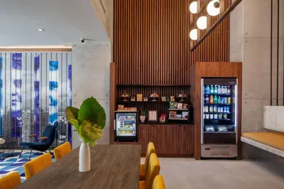 a restaurant with a table and a drink refrigerator at Hotel Indigo Miami Brickell by IHG in Miami