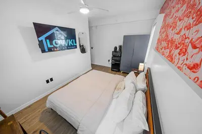 a small room with a bed and a sign on the wall at Greenview Hotel By Lowkl in Miami Beach