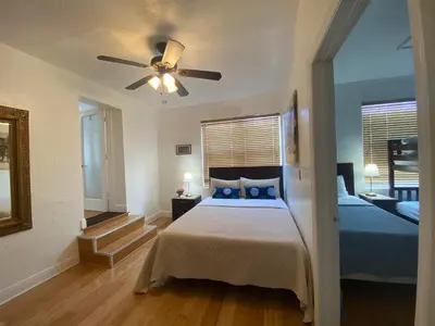 a bedroom with a bed and a ceiling fan at Miami Beach Rooms B&B in Miami Beach