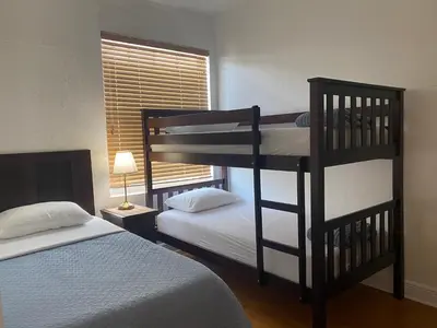 a bedroom with two bunk beds and a window at Miami Beach Rooms B&B in Miami Beach