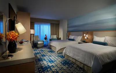 a hotel room with two beds and a desk at Seminole Hard Rock Hotel & Casino Hollywood in Fort Lauderdale