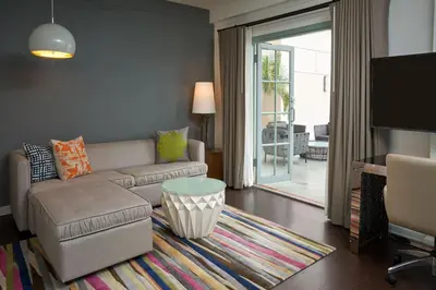 a living room with a couch and a table at Hotel Colonnade Coral Gables, Autograph Collection in Miami