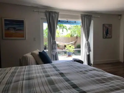 a bedroom with a bed in front of a window at Little havana paradise in Miami