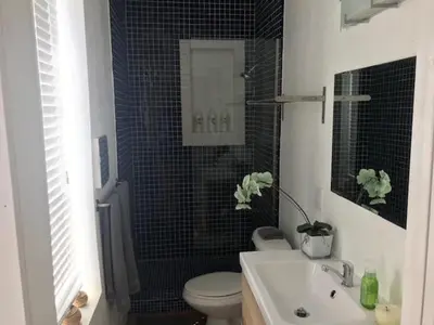 a bathroom with a toilet and a sink at Little havana paradise in Miami