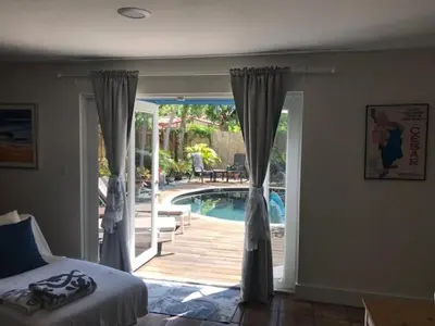 a bedroom with a door open to a swimming pool at Little havana paradise in Miami