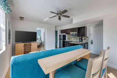 a living room with a blue couch and a table at Hilton Vacation Club Crescent on South Beach Miami in Miami Beach