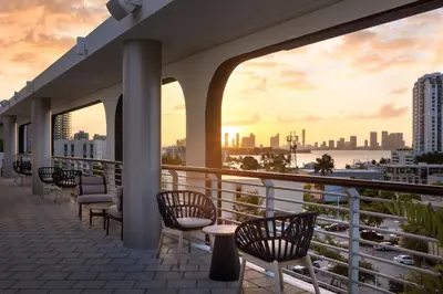 a balcony with chairs and a view of the city at Kimpton - Hotel Palomar South Beach by IHG in Miami Beach