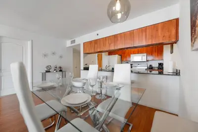 a dining room and kitchen with a glass table and chairs at Fabulous apartment in Brickell in Miami