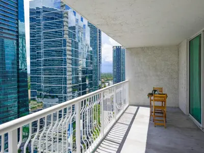 a balcony with a chair and a view of a city at Fabulous apartment in Brickell in Miami