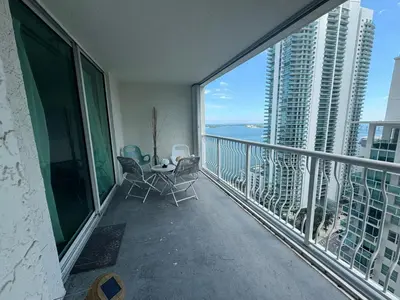 a balcony with a table and chairs and a view of the ocean at Fabulous apartment in Brickell in Miami