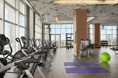 a gym with treadmills and exercise equipment and a green ball at Hyde Beach House in Hollywood