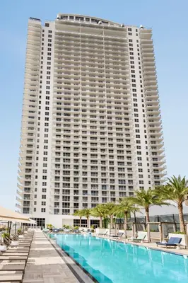 a large building with a large swimming pool and palm trees at Hyde Beach House in Hollywood