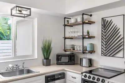 a kitchen counter with a sink and a microwave at Alani Bay Premium Condos in Fort Lauderdale