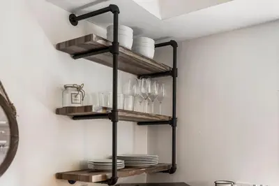 a kitchen shelf with plates and glasses on it at Alani Bay Premium Condos in Fort Lauderdale