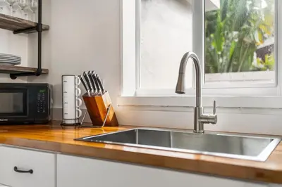 a kitchen sink with a microwave and a window at Alani Bay Premium Condos in Fort Lauderdale