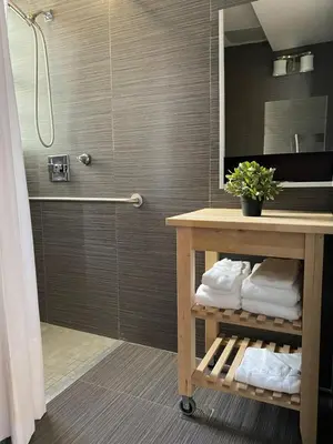 a bathroom with a sink and a shower with a mirror at Harding Boutique Apartments in Miami Beach