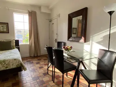 a dining room with a glass table and chairs at Harding Boutique Apartments in Miami Beach