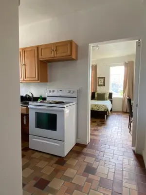 a kitchen with a white stove top oven in a room at Harding Boutique Apartments in Miami Beach