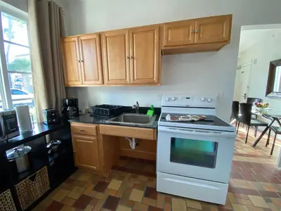 a kitchen with a white stove and a sink at Harding Boutique Apartments in Miami Beach