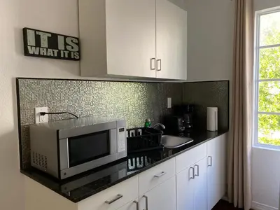 a kitchen with a microwave and a sink at Harding Boutique Apartments in Miami Beach