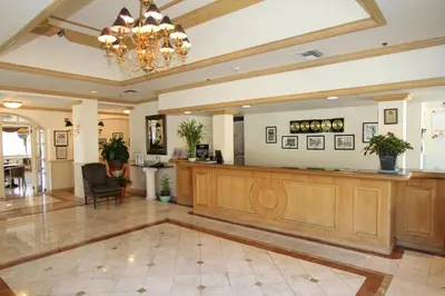 a large lobby with a large wooden reception desk at Hotel Chateaubleau in Miami