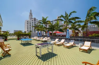 a deck with a ping pong table and chairs at Catalina Hotel & Beach Club in Miami Beach