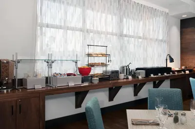 a restaurant with a counter with food on it at Four Points by Sheraton Fort Lauderdale Airport/Cruise Port in Fort Lauderdale