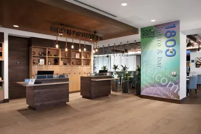 a lobby of a store with a sign on the wall at Four Points by Sheraton Fort Lauderdale Airport/Cruise Port in Fort Lauderdale