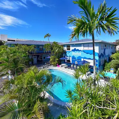 a view of a resort with a swimming pool and palm trees at Blue Bell Apartment Hotel in Fort Lauderdale