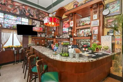 a bar in a restaurant with a large counter at Hotel Chelsea in Miami Beach
