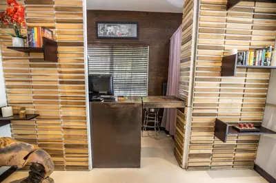 a room with a wooden wall with a desk in it at Metropole Suites South Beach in Miami Beach