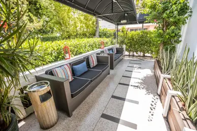 a patio with a couch and some plants at Metropole Suites South Beach in Miami Beach