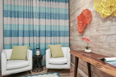two white chairs and a wooden table in a room at Chesterfield Hotel & Suites in Miami Beach