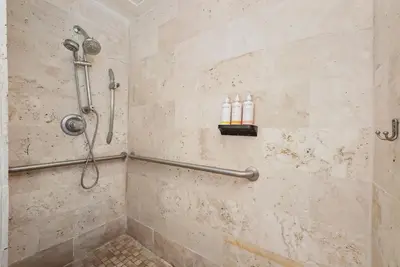 a bathroom with a shower with two bottles at Whitelaw Hotel in Miami Beach
