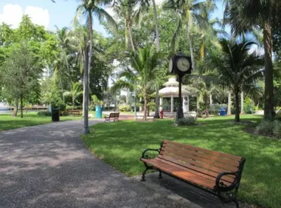 a park with a bench and a clock tower at Designer River View Apartments in Fort Lauderdale