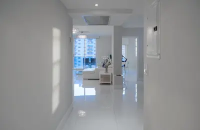 a white living room with a couch and a table at Cozy and Luminous Apartment - 00388 in Miami Beach