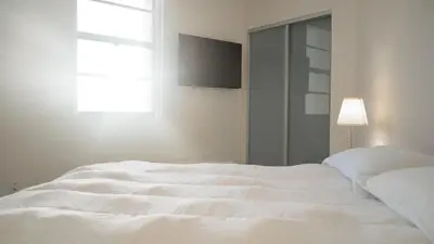 a white bed in a bedroom with a window at Cozy and Luminous Apartment - 00388 in Miami Beach