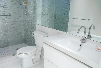 a white bathroom with a toilet and a sink at Cozy and Luminous Apartment - 00388 in Miami Beach
