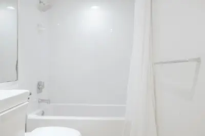 a white bathroom with a shower and a toilet at Cozy and Luminous Apartment - 00388 in Miami Beach