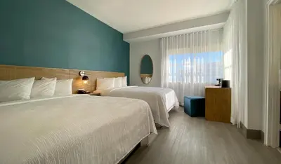 a hotel room with two beds and a window at Marseilles Beachfront Hotel in Miami Beach