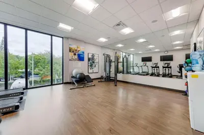 a gym with treadmills and elliptical machines at Comfort Inn & Suites Miami International Airport in Miami