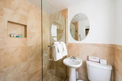 a bathroom with a shower and a toilet and a sink at Majestic Hotel South Beach in Miami Beach