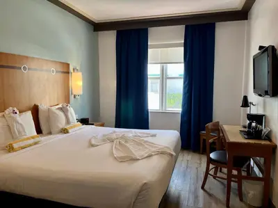 a hotel room with a large bed and a window at Majestic Hotel South Beach in Miami Beach